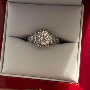 Engagement ring. 
White gold 
All diamonds around ring, moissanite center $500